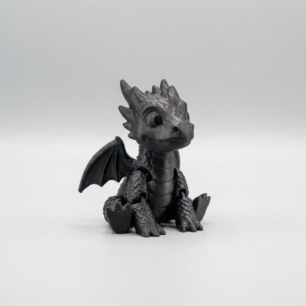 3D printed black articulated flexi baby dragon toy