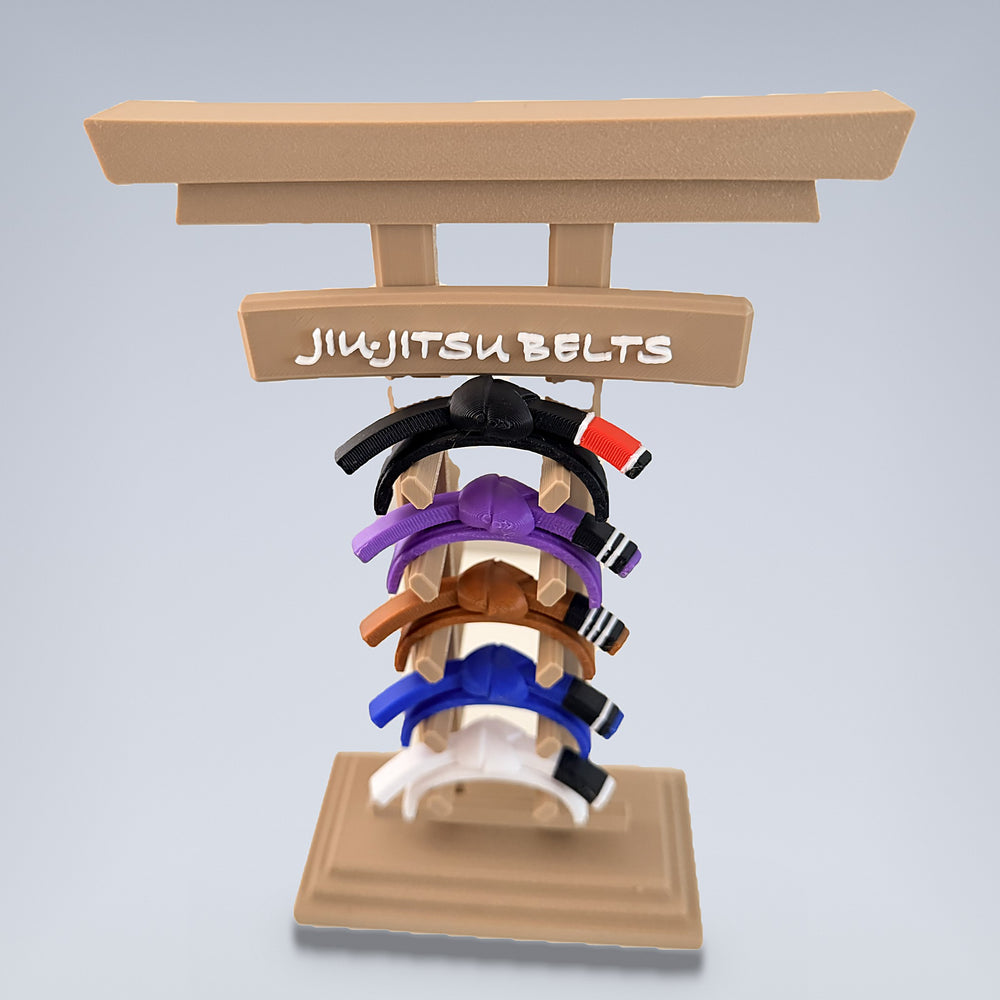 Torii gate jiu-jitsu belt rack holding white, blue, purple, brown and black belts