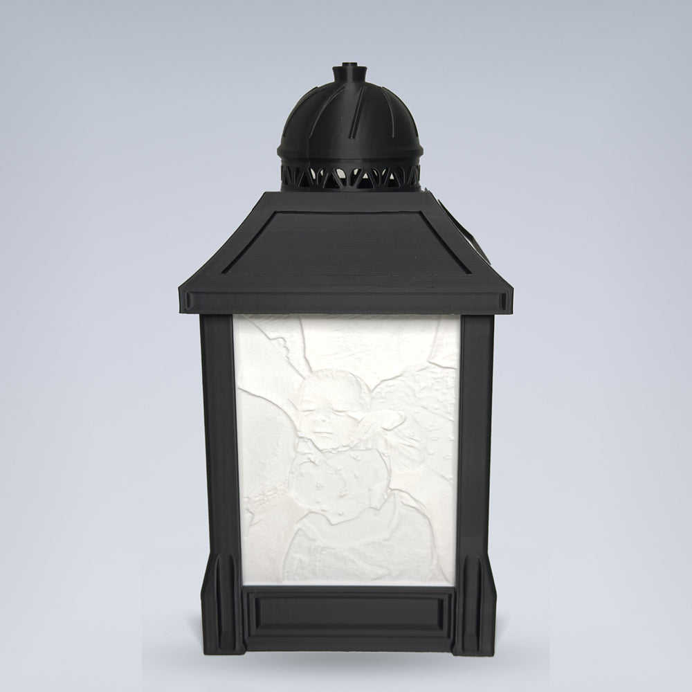 Custom lithophane photo lamp — black 3D printed lantern by day with sculpted photo relief panel, studio background