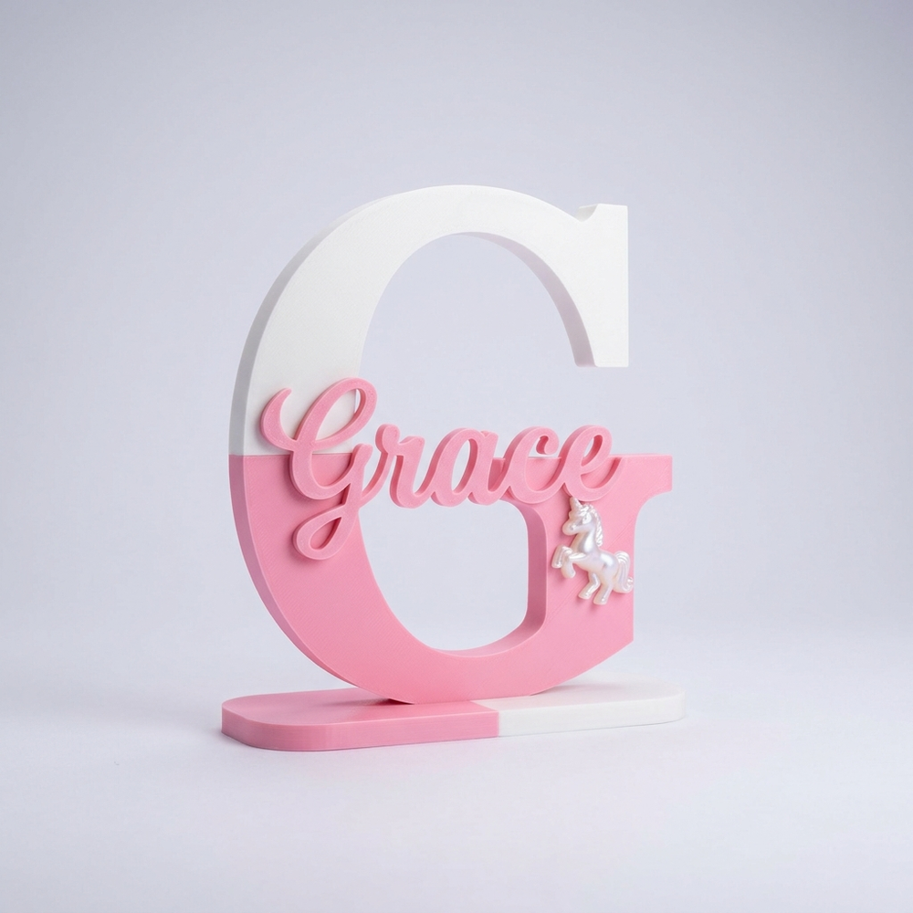 3D printed pink letter G name sign with unicorn