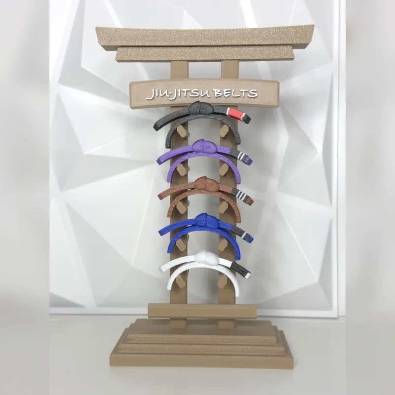 Torii gate belt rack holding white, blue, purple, brown and black jiu-jitsu belts