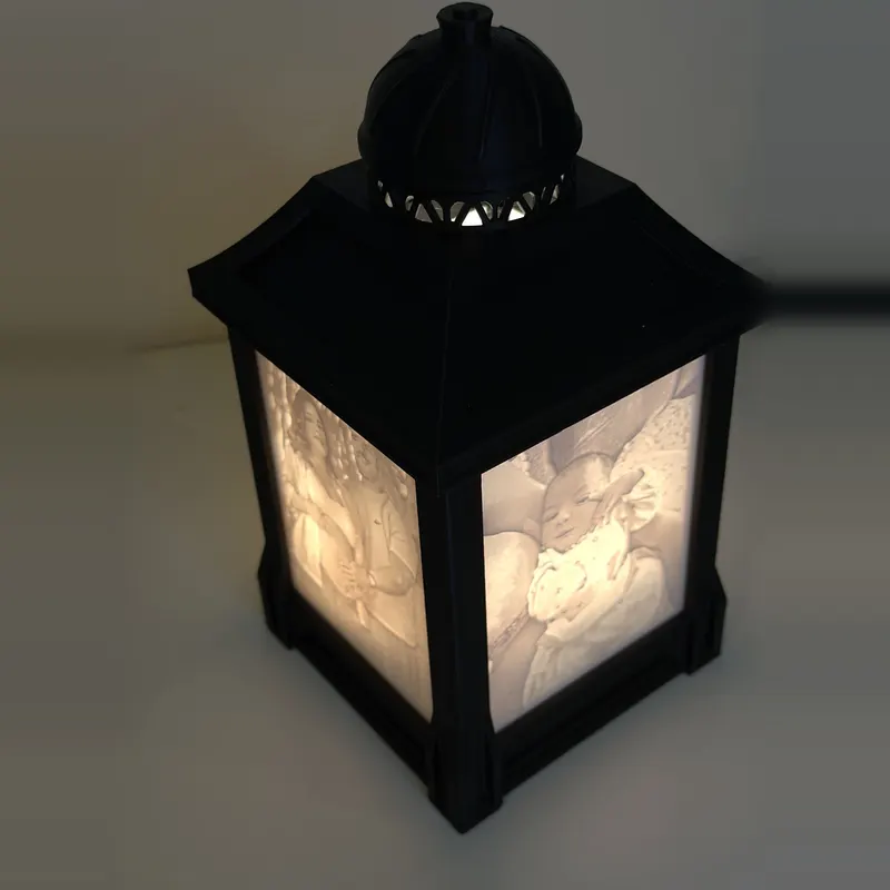 Custom lithophane photo lamp lit at night, seen from an angle